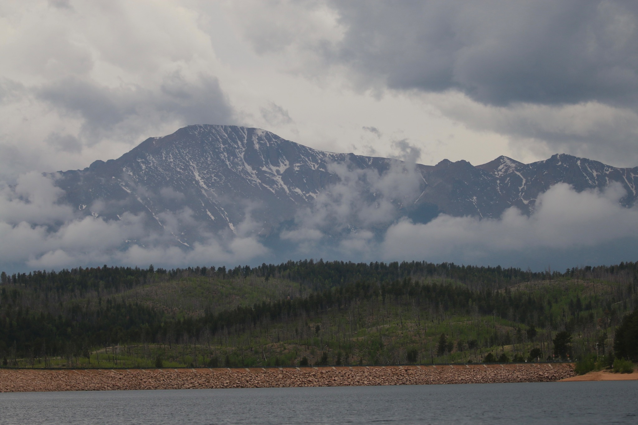 Mountain ridge disappearing into dramatic storm clouds